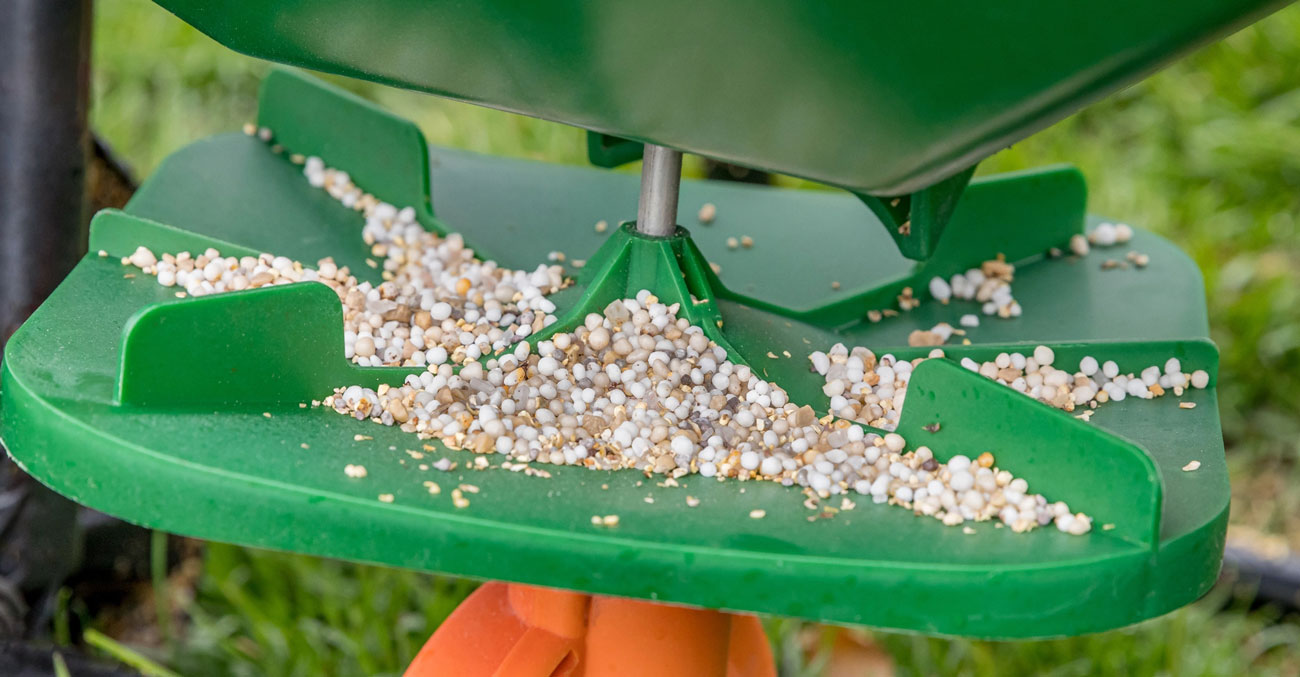 Close-up of a lawn fertilizer machine.